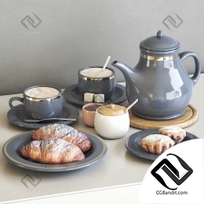 Tea set with croissants and cupcakes